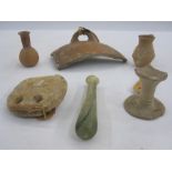 Roman terracotta loom weight, 9cm diameter approx, a small Roman glass bottle, 12.5cm high and