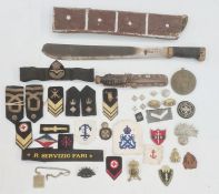 Collection of British cap badges, naval badges and rank markings, one box and a WWII machete