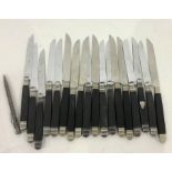 Quantity of French Chastel ebony-handled knives with silver-coloured metal mounts, some with