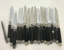 Quantity of French Chastel ebony-handled knives with silver-coloured metal mounts, some with