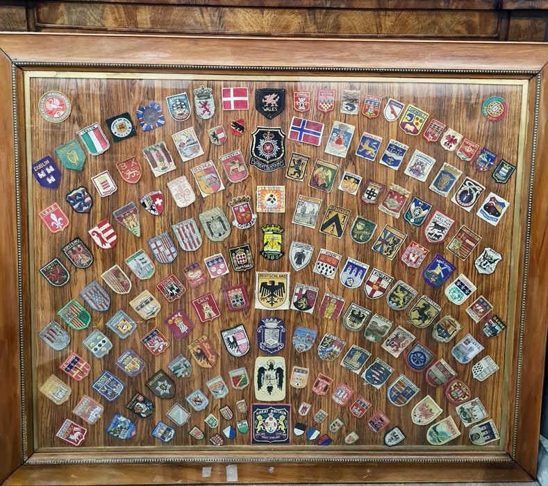Large framed collection of various badges to include German, Great Britain, Italian and other