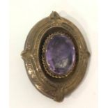 Victorian amethyst oval brooch in gold-coloured mount, set single facet-cut stone, 5cm high