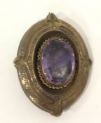 Victorian amethyst oval brooch in gold-coloured mount, set single facet-cut stone, 5cm high