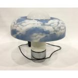 Large 1970's plastic table lamp with circular shade of blue sky and clouds, on cylindrical base with