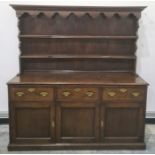 Possibly 18th century oak dresser with ogee moulded pediment above two shelves, the base of three