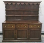 Possibly 18th century oak dresser with ogee moulded pediment above two shelves, the base of three