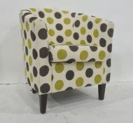 Modern armchair, cream ground with black and green spots