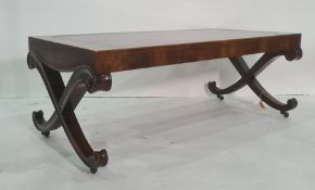 20th century mahogany and leather-topped rectangular coffee table, on curvy X-end supports to