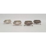 Set of four Victorian silver salts, cauldron shaped, each floral embossed and on three paw feet,
