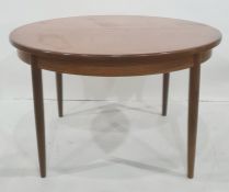 20th century teak, probably G-Plan, D-end extending dining table with circular tapering legs,