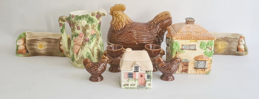 Two Eastgate pottery fauna pattern flower troughs, a Beswick cottage biscuit barrel, a hen covered