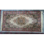 Modern cream ground rug with central medallion, blue ground spandrels, pink border, 171 x 84cm