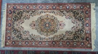 Modern cream ground rug with central medallion, blue ground spandrels, pink border, 171 x 84cm