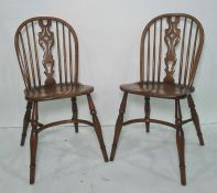 Set of four 20th century elm seated dining chairs with crinoline stretchers, turned legs, shaped and