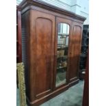 19th century mahogany wardrobe compactum, the moulded pediment with central mirrored door opening to