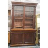 Late 19th century mahogany bookcase cabinet with ogee moulded pediment, above two glazed doors