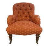 Late Victorian chair with pink button back upholstery, on turned front legs to black china castors