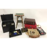 Assorted suitcases and small green tiled square two-tier occasional table and a Singer sewing