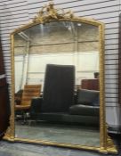 Large 20th century overmantel mirror with arched top, surmounted by putto amongst scrolling