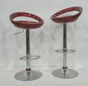 Pair of red seated plastic and chrome based breakfast bar stools (2)  please see additional images