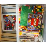 A large quantity of loose Lego, figures, wheels, trees, base boards, various instruction manuals (
