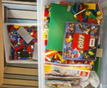 A large quantity of loose Lego, figures, wheels, trees, base boards, various instruction manuals (