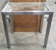 Rectangular coffee table with glass top and brushed metal body