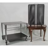 Modern two-tier low hostess trolley / tv stand on castors in black and chrome, a circular coffee