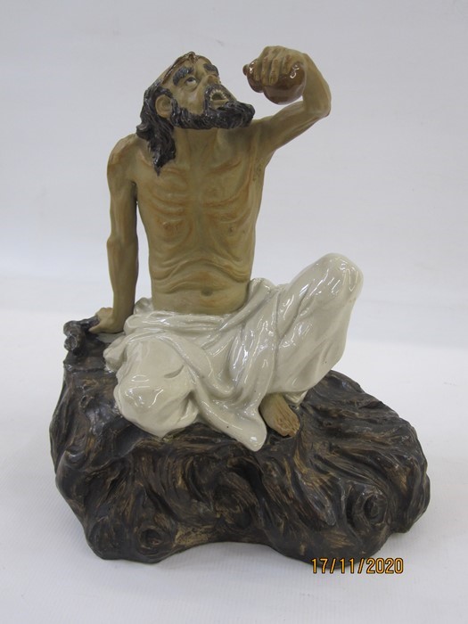 Chinese porcelain and partly glazed model of a seated mudman  (Li Tieguai), one of the eight