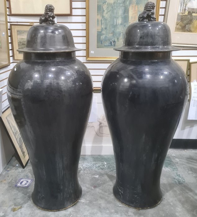 Pair of large Oriental floor standing porcelain covered meiping vases, each with dog of fo finial to