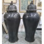 Pair of large Oriental floor standing porcelain covered meiping vases, each with dog of fo finial to