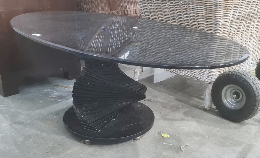 Modern glass coffee table, the oval top on stepped spiralling pedestal, to circular base, 118cm wide