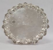 Victorian silver card tray with raised scallop shell and C-scroll border, engraved dolphin crest