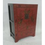 Chinese-style cabinet finished in red lacquer, with gilt decoration, two doors enclosing shelves, on