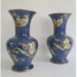 Pair of Rialto ware blue lustre vases decorated with butterflies (one repaired) (2)