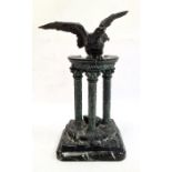 Bronzed metal statue of an eagle atop pillared ruins, on rectangular marbled base, unsigned, 33cm