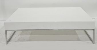 Rectangular white perspex coffee table on chromed base, 110cm x 30cm