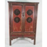 Chinese-style marriage cabinet painted black and red, two doors enclosing various shelves and