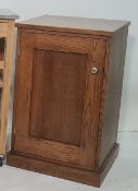 Modern oak cupboard, the rectangular top above single cupboard door, on plinth base, probably by