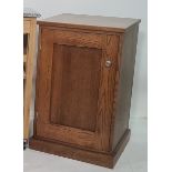 Modern oak cupboard, the rectangular top above single cupboard door, on plinth base, probably by