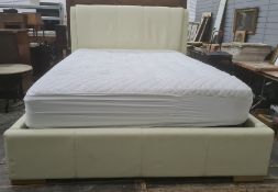 Double bed with cream upholstered headboard, lift-up base, with mattress, 52" wide approx and a baby