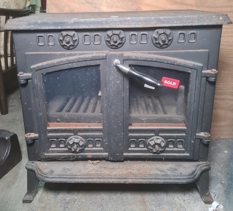 Cast iron stove with two glazed doors, 63cm x 60cm Condition ReportThe depth is 38cm or 44cm