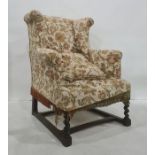 Early 20th century wingback armchair on barleytwist front supports, stretchered base