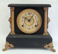 Mantel clock with arabic numerals, painted black body and gold painted highlights, chiming