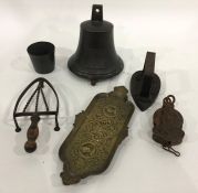 Old bronze bell with embossed roundel, 23cm high, cast metal pulley, old flat iron and a stand