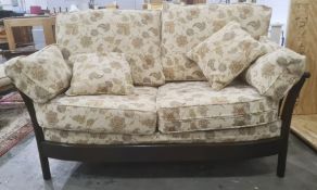 Dark elm Ercol two-seat sofa and single armchair in beige ground upholstery (2)