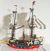 A Lego pirate ship with Lego pirates, parrots and monkey, 49cm high x 47cm long