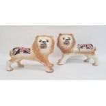 Pair of Staffordshire-style pottery lions painted with Union Jacks, 25cm high x 32cm long (2)