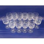 Set of 12 large Orrefors clear glass wines with floral etched design, on thick column stems and