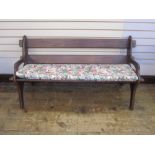 Dark wood bench with floral cushion and similar oval slatted coffee/occasional table, on straight